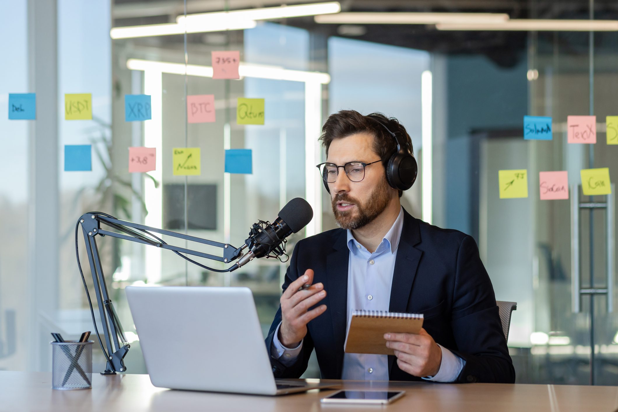 Businessman hosting podcast in modern office
